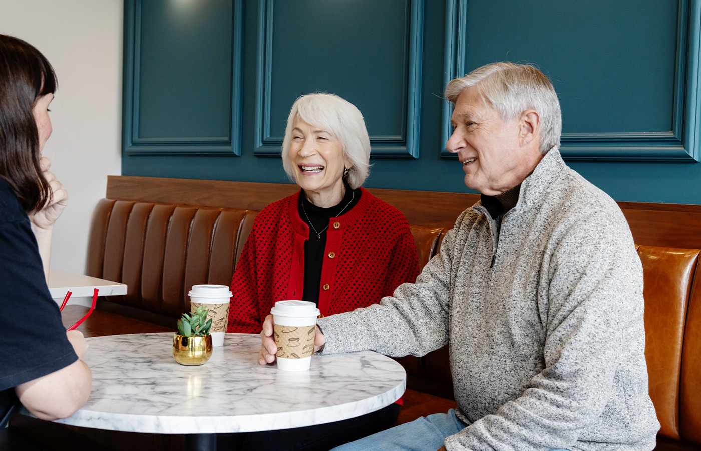 People at a cafe with coffee.