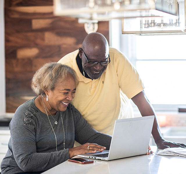 A couple on the computer at home.