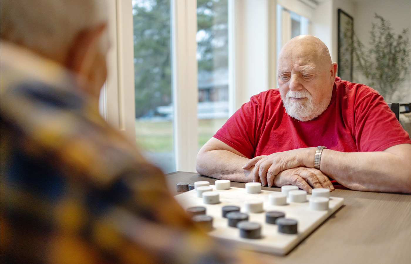 Two people playing checkers.