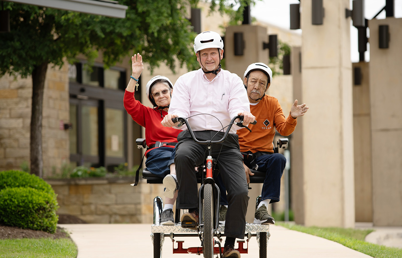 a person biking around two other people