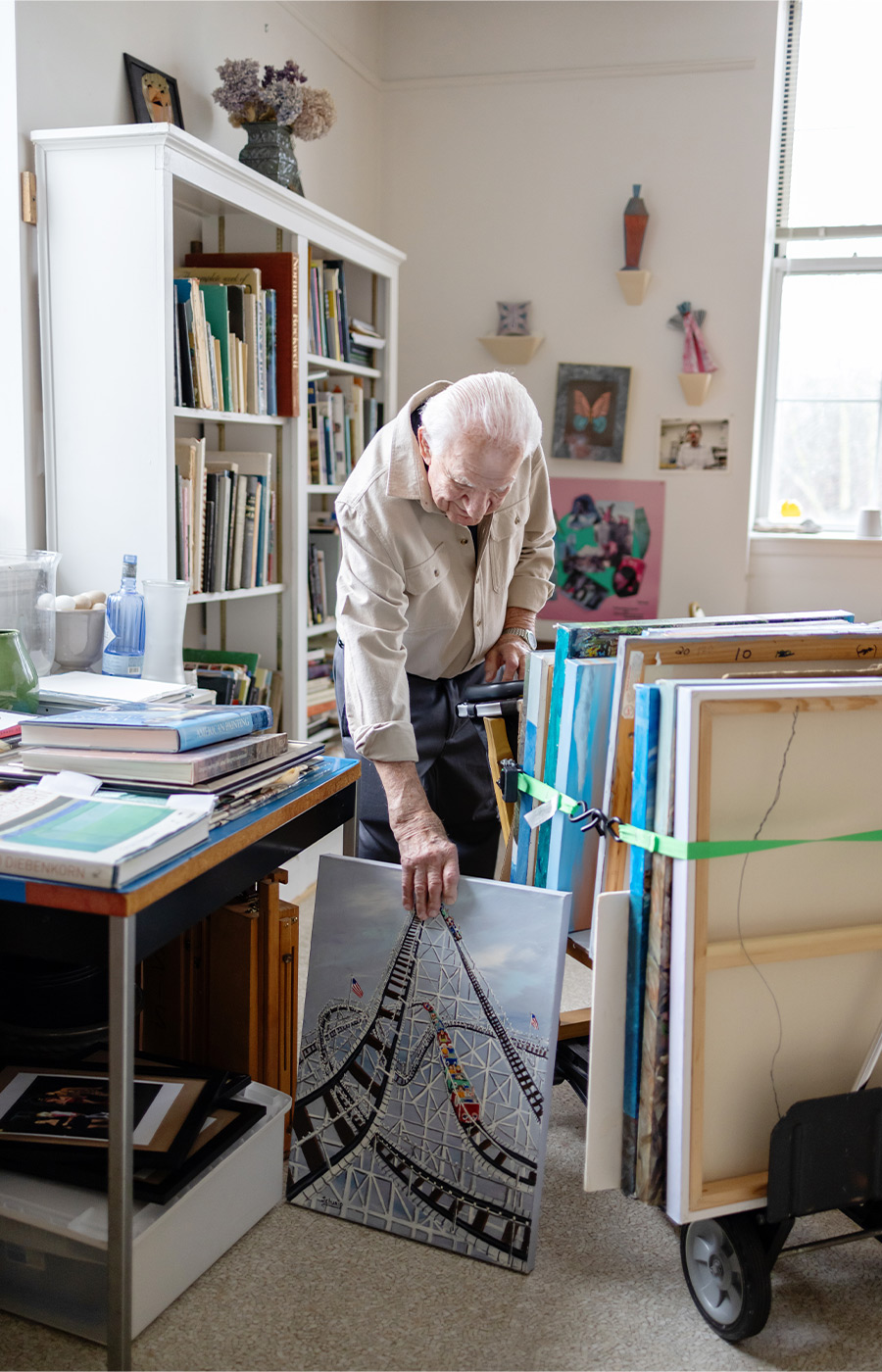 A person pulling out a painting.