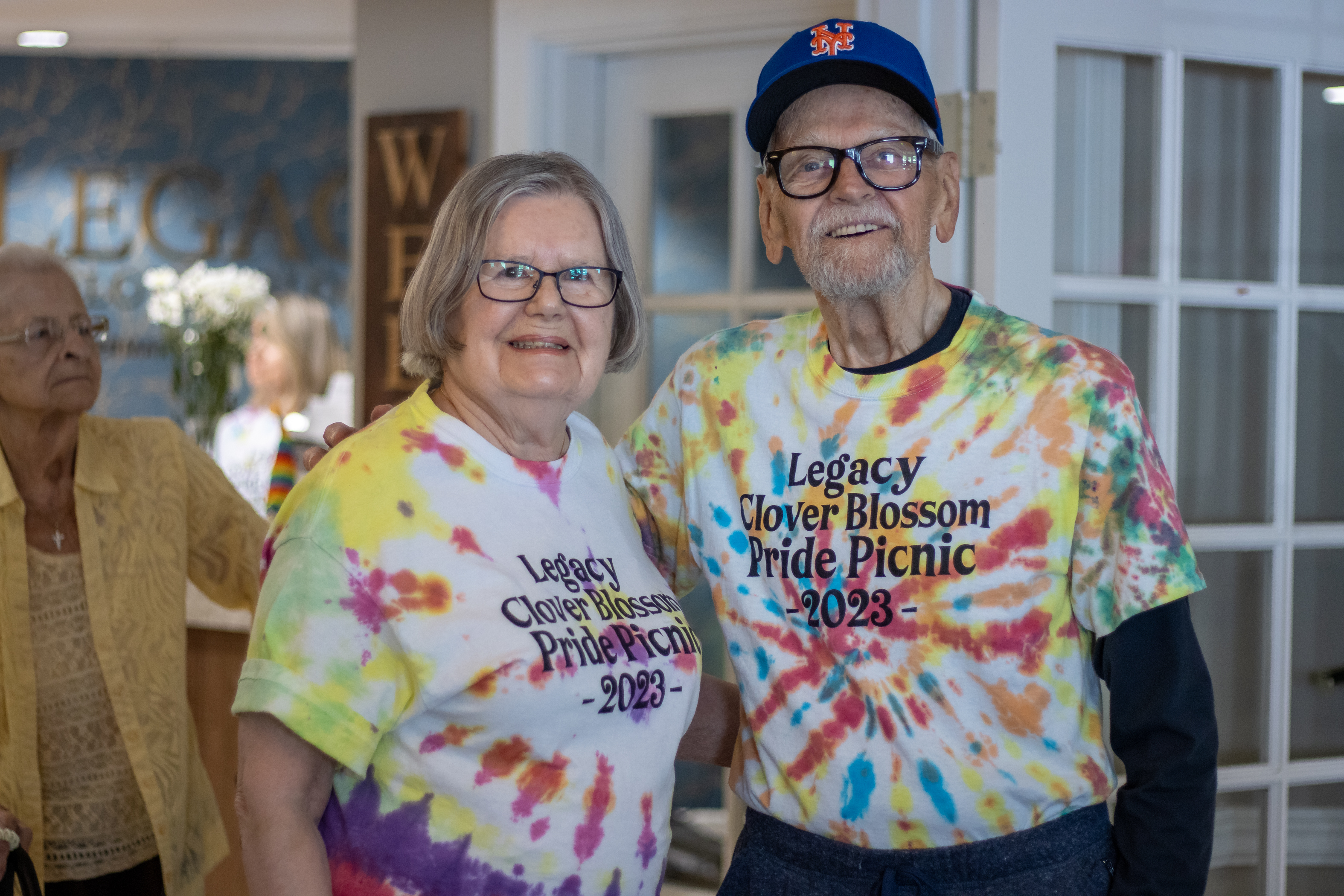 Two residents wearing pride shirts