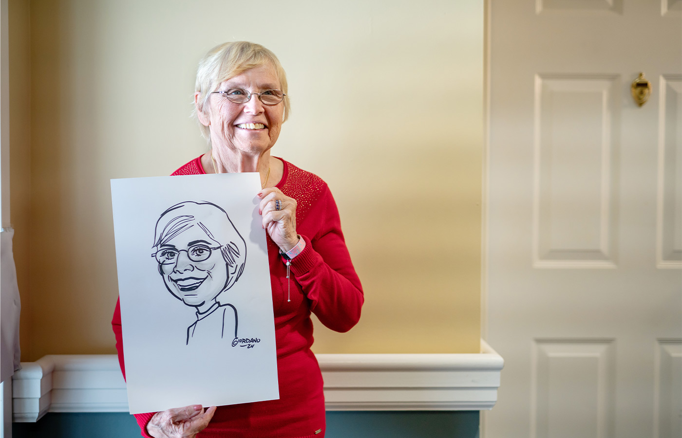 A person holding a drawing of themselves.