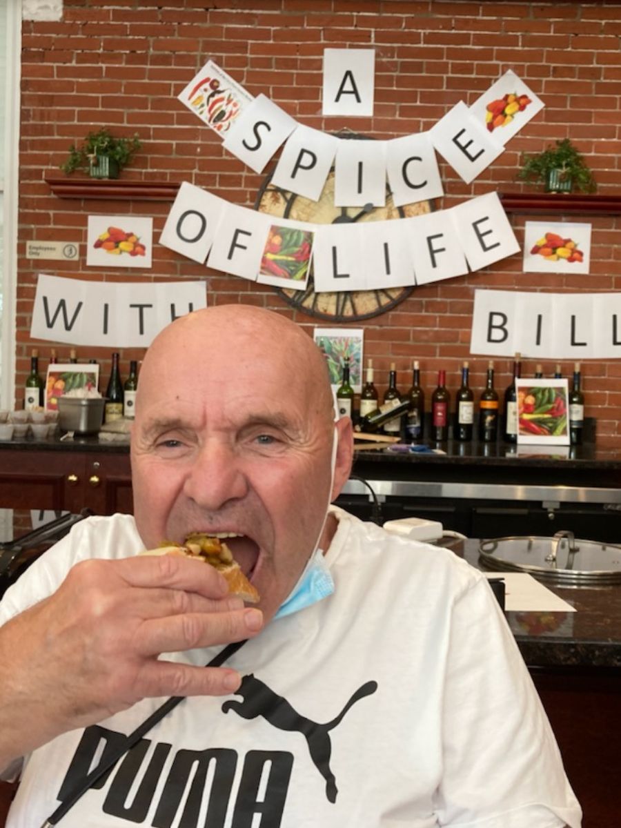 Bill, a resident, taking a bite of food.