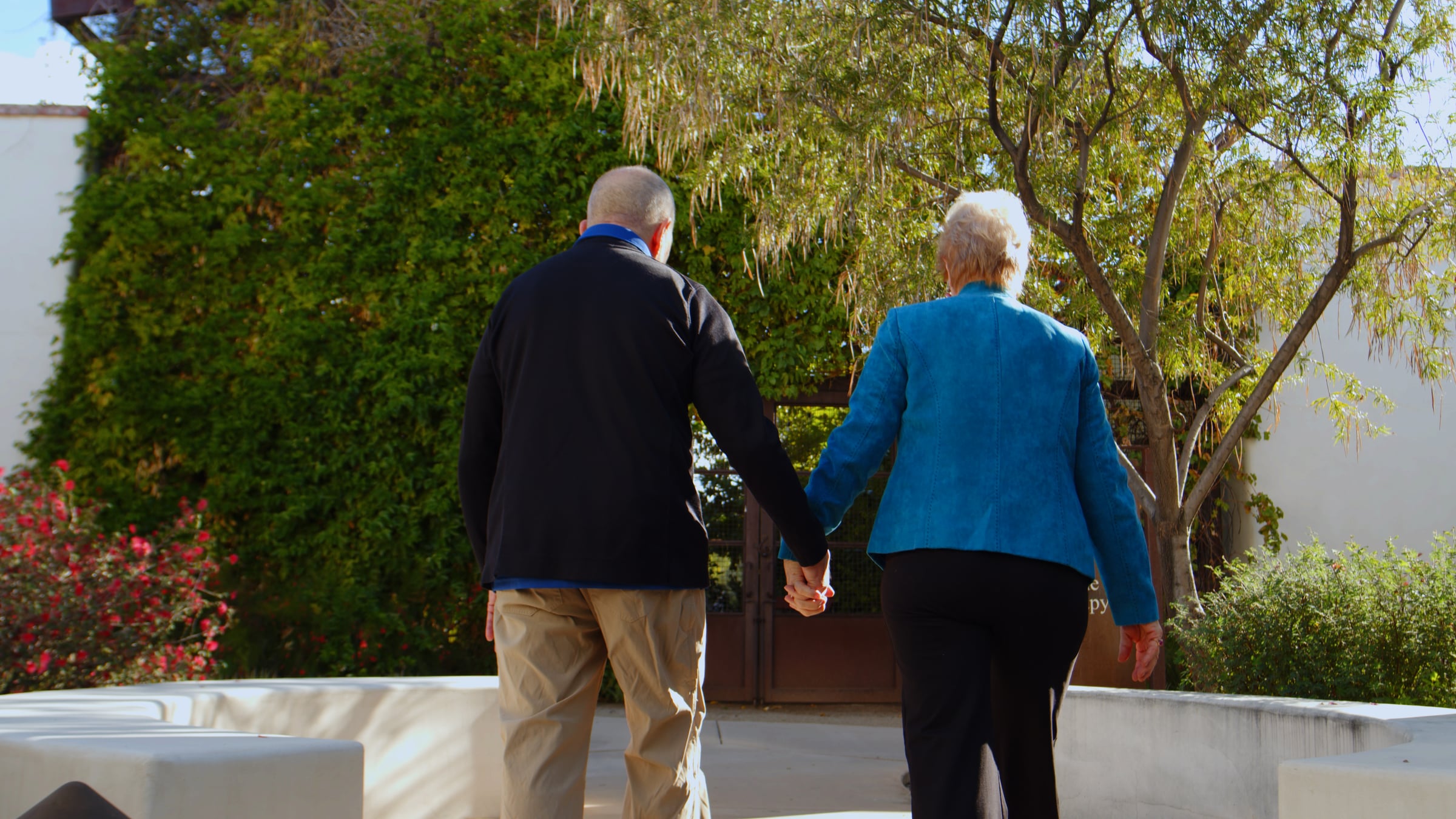 A couple holding hands.