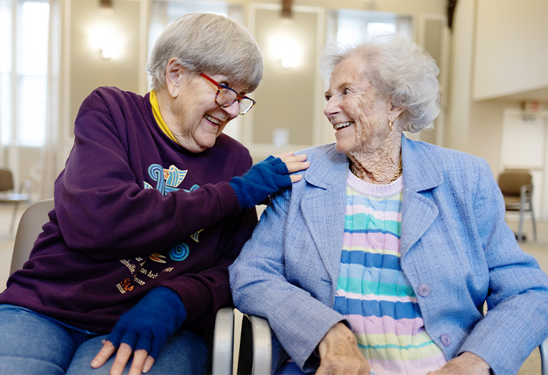 Two people sitting next to each other.