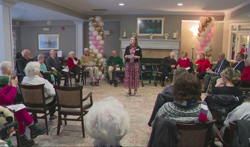 A person speaking in front of a group.