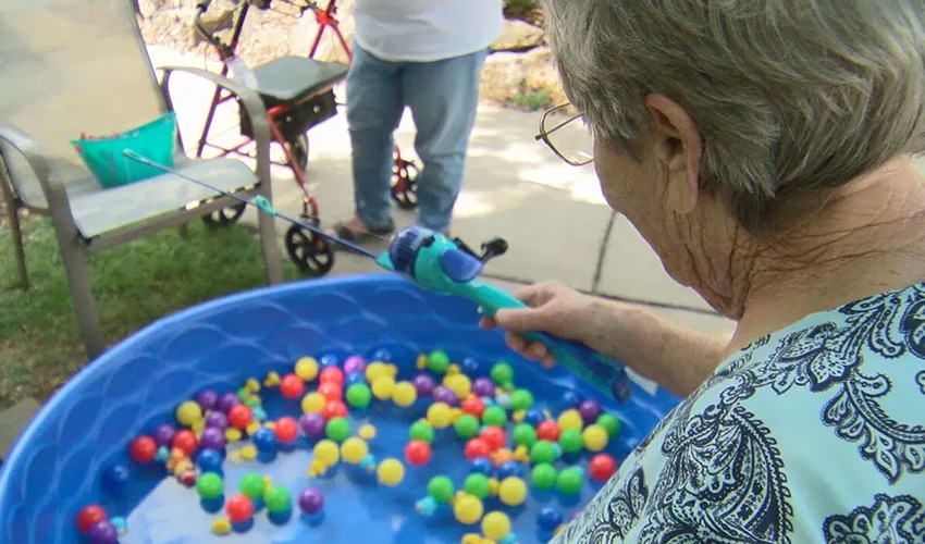 A person playing a carnival game.