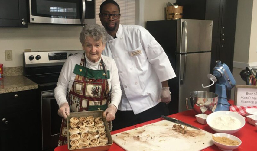 Two people making Cinnamon rolls.