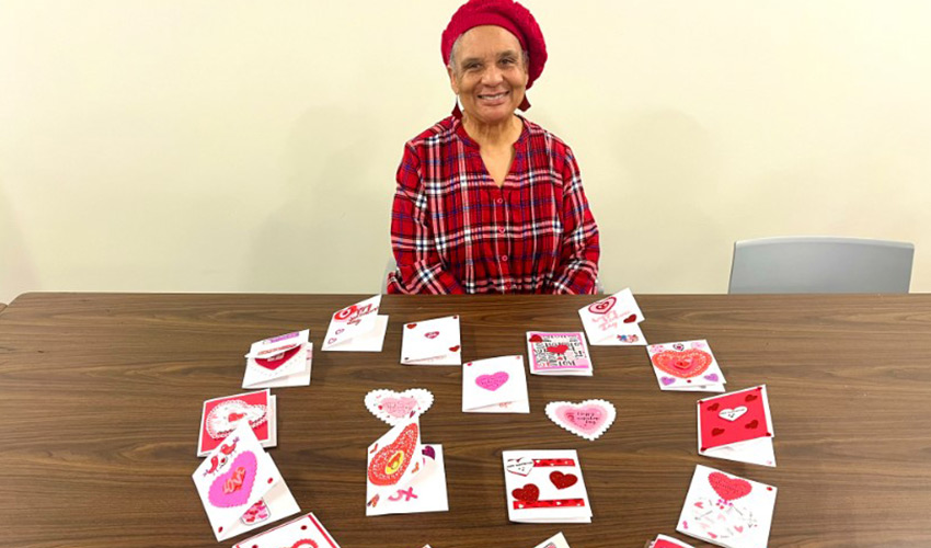 A person with a table full of handmade cards.