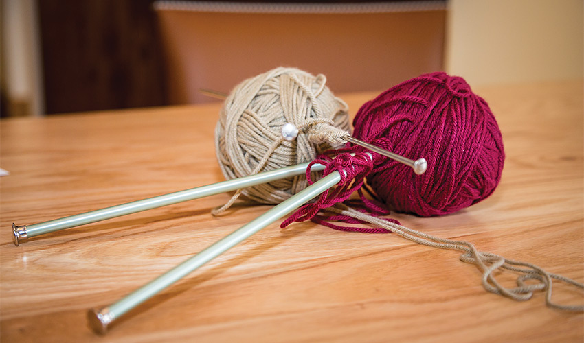 Balls of yarn with knitting needles.