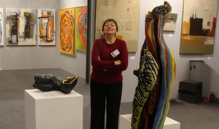 Luba standing by her sculpture.