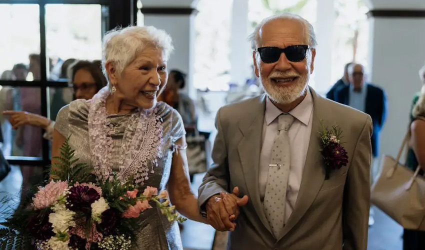 Two people walking down the aisle at a wedding.