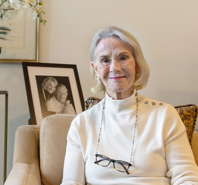 A person sitting and smiling.