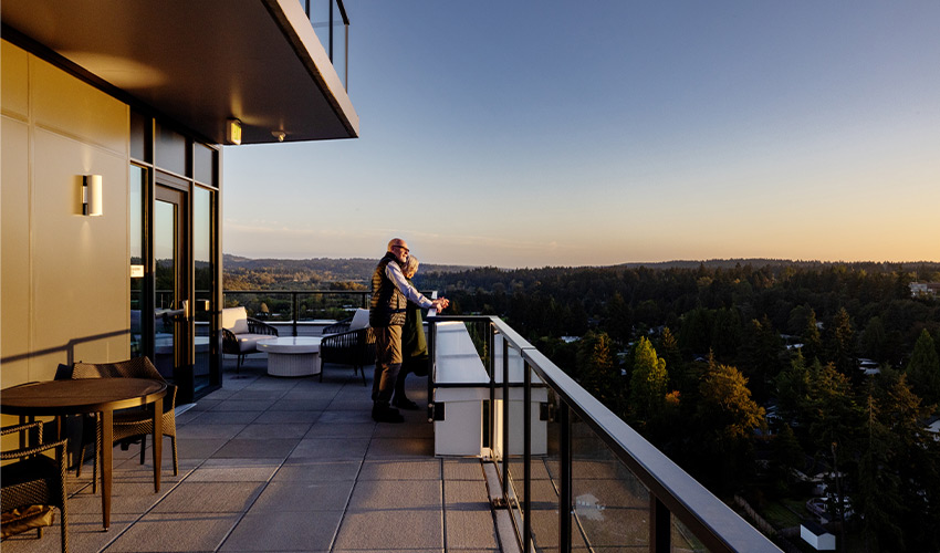 Two people out on a balcony.