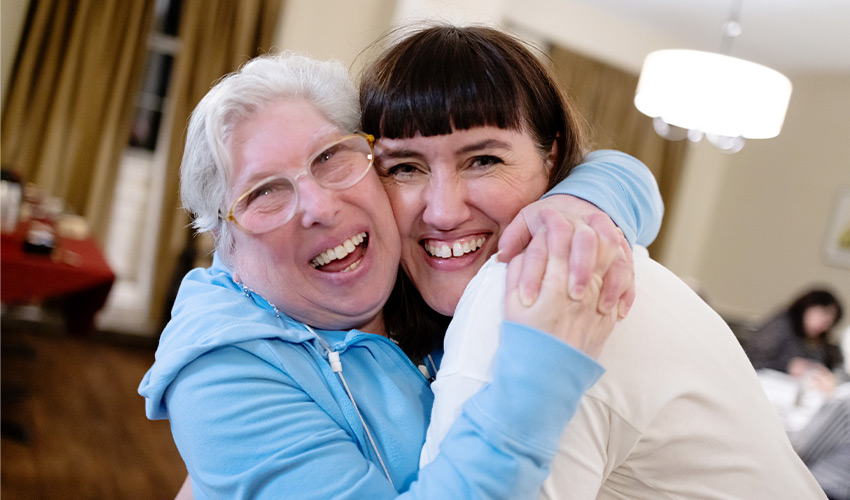 Two people hugging.